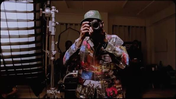 A person holding a camera inside a film lab.